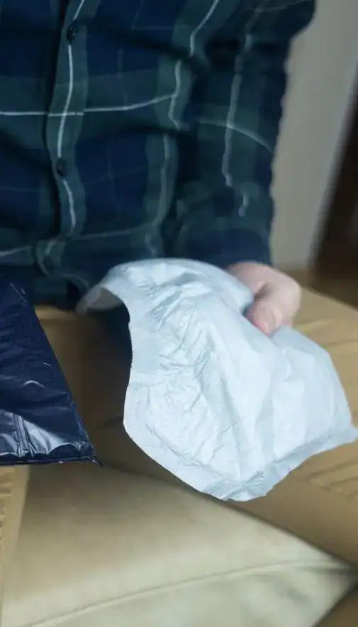 Image of man holding incontinence pads as part of overactive bladder treatment Bolton