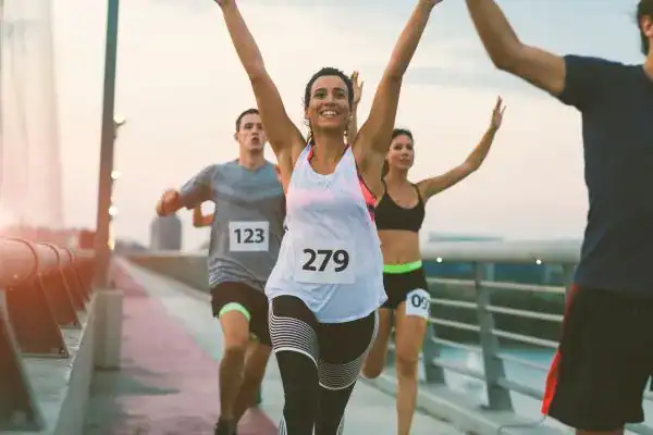 woman running happy arms up with no concern of stress incontinence Bolton