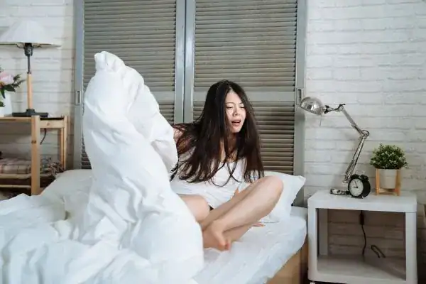 Image of woman getting up because of nighttime leaks Bolton